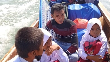 Help The Students To Reach The School Using a Boat across Island, Propos, Riau Island Province, Indonesia 